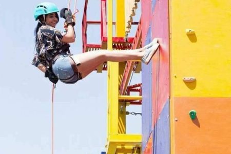 Guests enjoying an exciting rappelling activity at Prathamesh Resort, Pune, with professional safety gear and stunning natural surroundings.